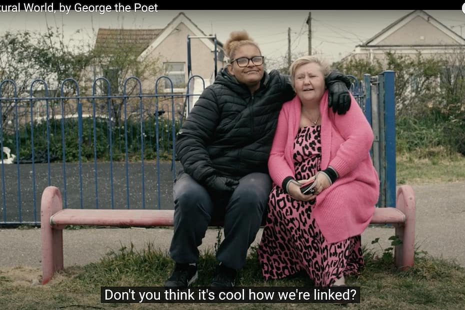 woman with arm around another on park bench