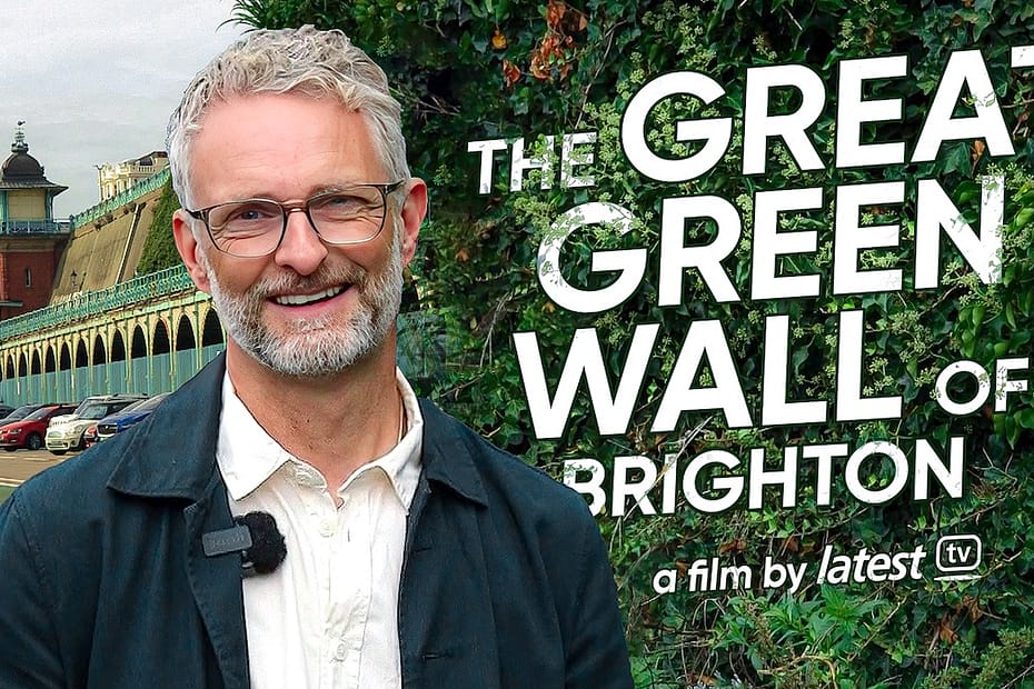 smiling man with glasses and climbing plants